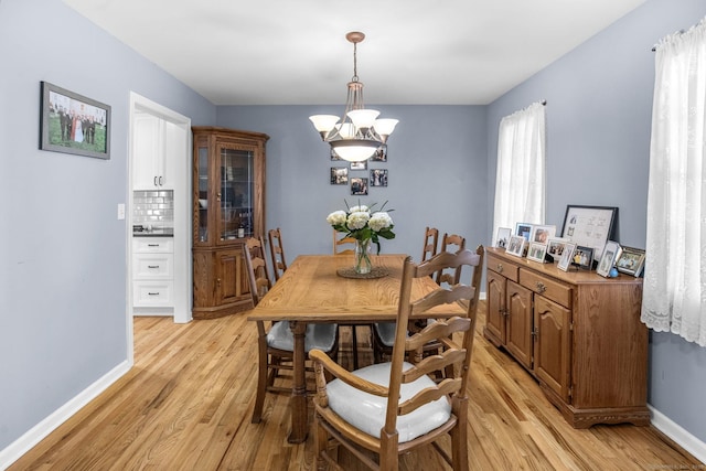 dining space featuring a chandelier and light wood-type flooring