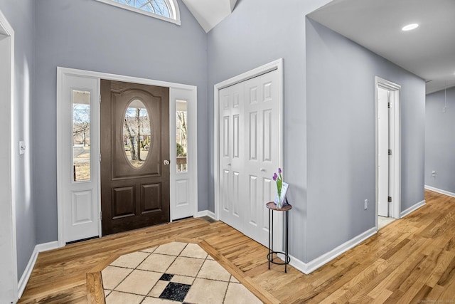 foyer with lofted ceiling and hardwood / wood-style floors