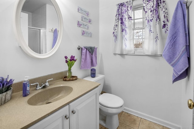 bathroom featuring vanity, tile patterned floors, toilet, and walk in shower