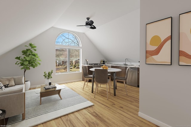 interior space with ceiling fan, lofted ceiling, sink, and light hardwood / wood-style floors