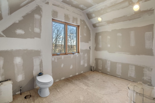 bathroom featuring vaulted ceiling and toilet