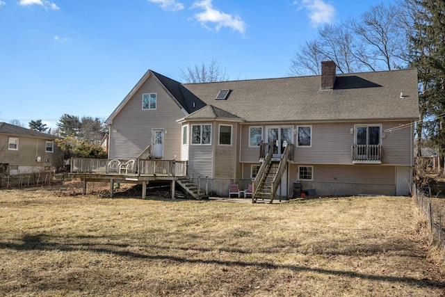 back of property with a lawn and a deck