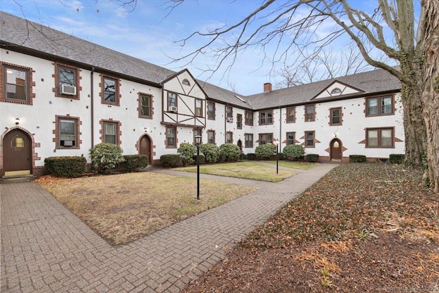 exterior space with a front lawn and cooling unit