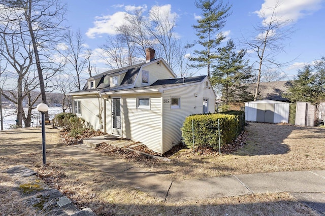 view of side of home with a storage unit