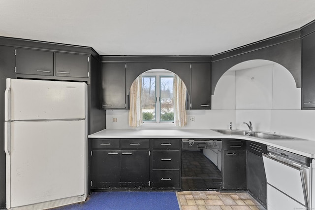 kitchen with white fridge, black dishwasher, and sink