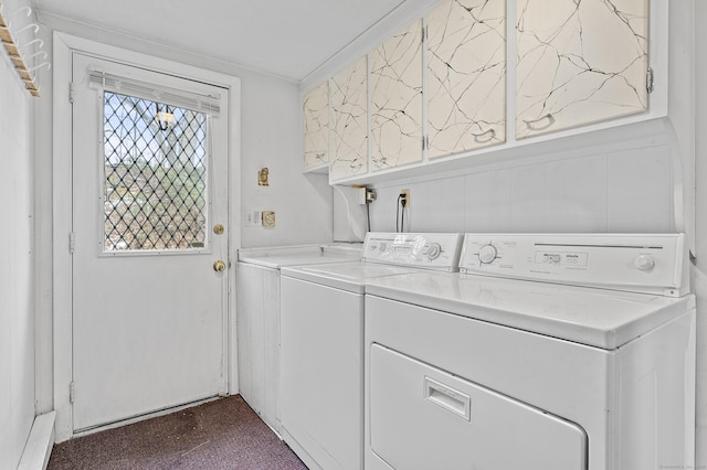 laundry area with washer and clothes dryer and cabinets