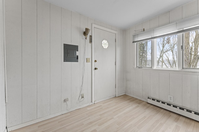 foyer featuring a baseboard radiator, electric panel, and light hardwood / wood-style floors