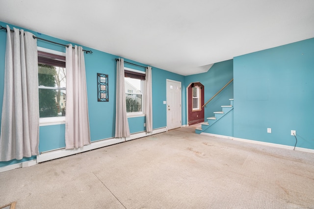 interior space featuring baseboard heating and carpet flooring