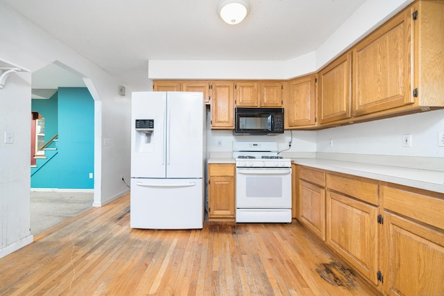 kitchen featuring white appliances and light wood-type flooring