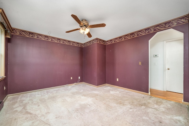 carpeted empty room featuring ceiling fan