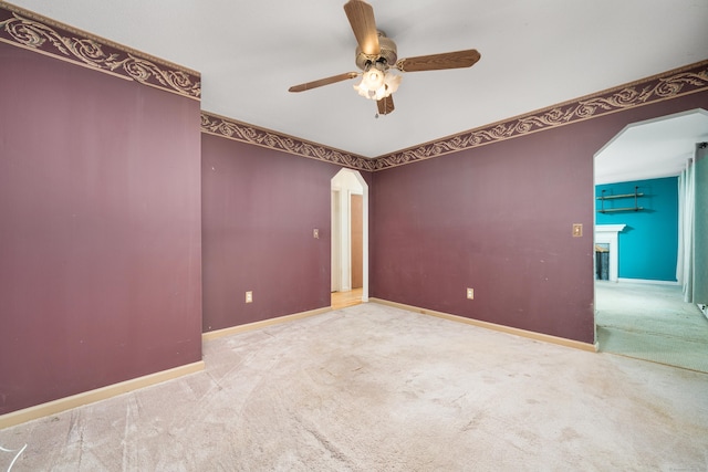 carpeted empty room with ceiling fan