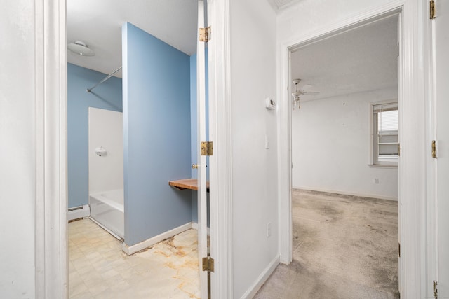 bathroom with a baseboard heating unit, a bath, and ceiling fan