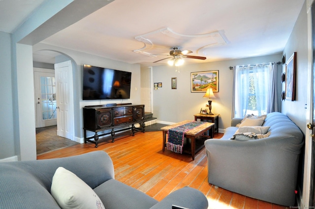 living room with wood-type flooring and ceiling fan