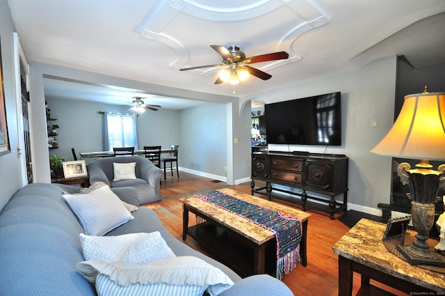 living room with hardwood / wood-style flooring and ceiling fan