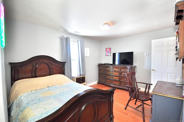 bedroom with hardwood / wood-style flooring