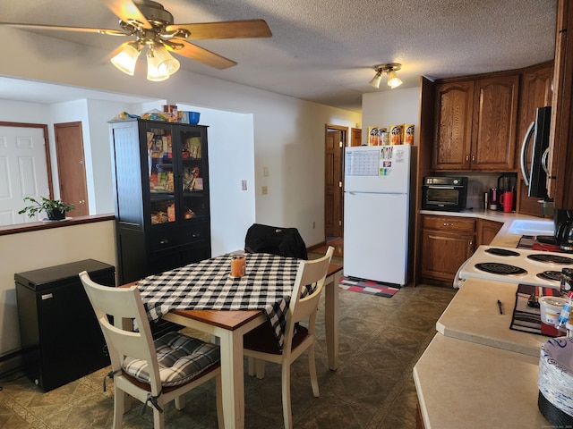 dining room featuring a textured ceiling and ceiling fan