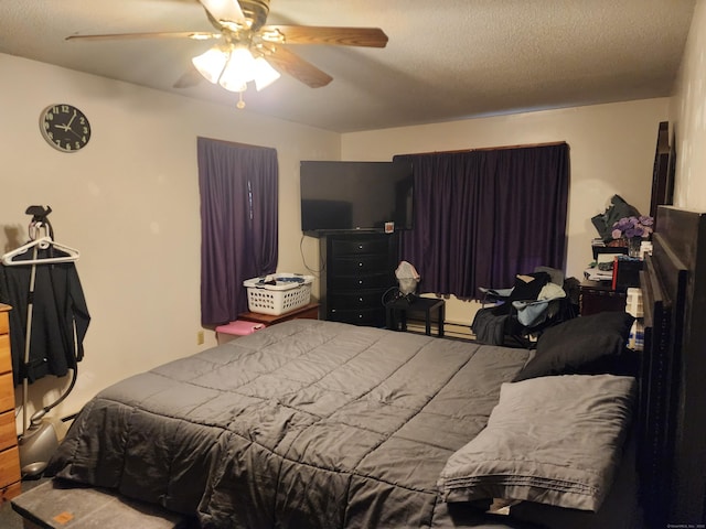 bedroom with a baseboard heating unit, a textured ceiling, and ceiling fan