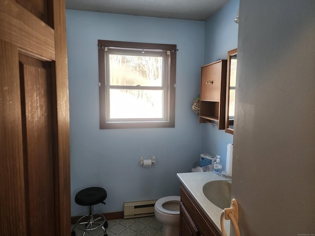 bathroom with baseboard heating, vanity, and toilet