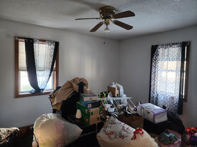 bedroom with a textured ceiling and ceiling fan