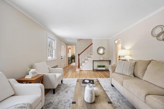 living room featuring hardwood / wood-style flooring and crown molding