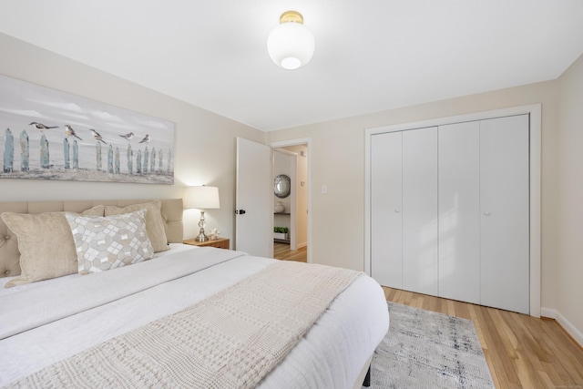 bedroom featuring light wood-type flooring and a closet