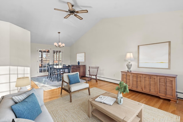 living room featuring lofted ceiling, a baseboard heating unit, light wood-type flooring, and ceiling fan with notable chandelier