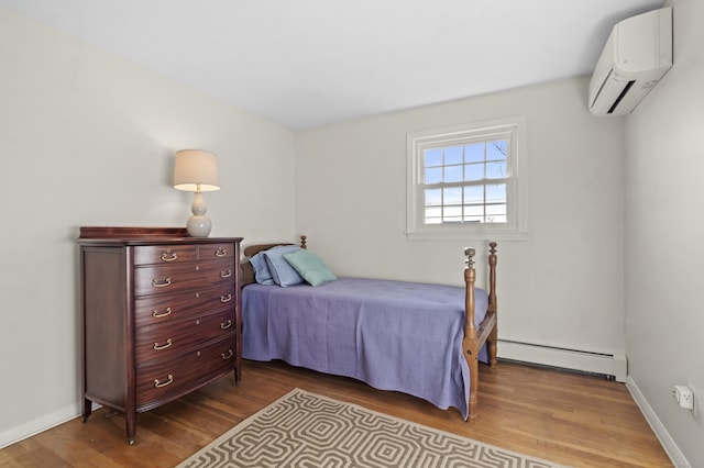 bedroom featuring a wall mounted AC, hardwood / wood-style floors, and a baseboard radiator