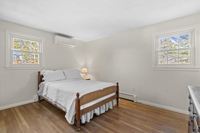 bedroom with dark wood-type flooring, baseboard heating, and a wall mounted air conditioner