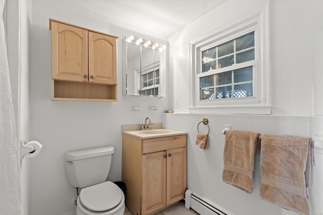 bathroom with toilet, vanity, and a baseboard radiator