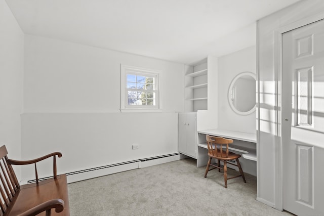 carpeted home office with a baseboard heating unit