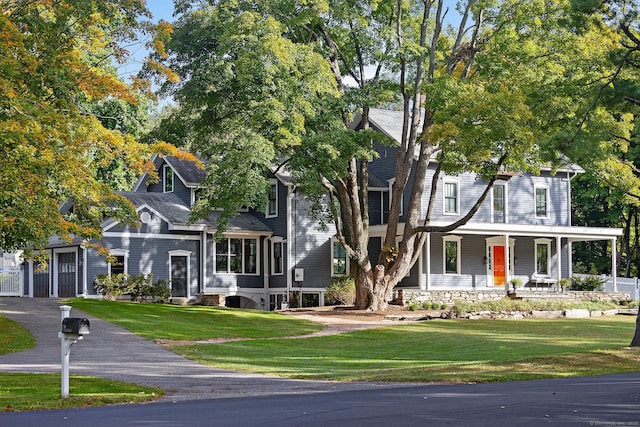 view of front of home with a porch and a front lawn