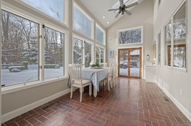 sunroom with ceiling fan and lofted ceiling