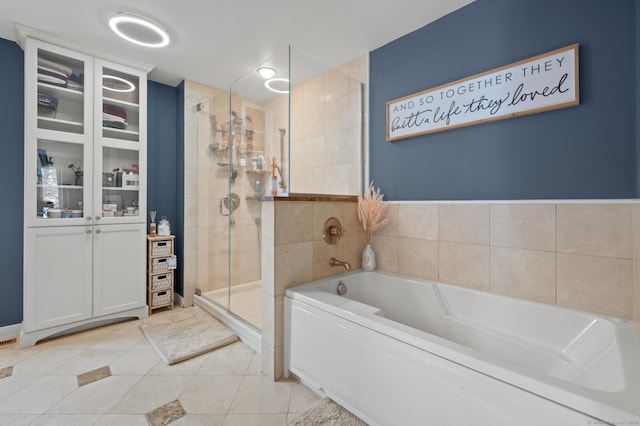 bathroom with tile patterned flooring and plus walk in shower