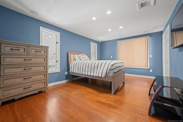 bedroom with wood-type flooring