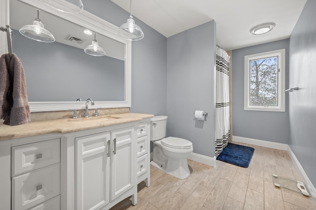 bathroom featuring vanity and toilet