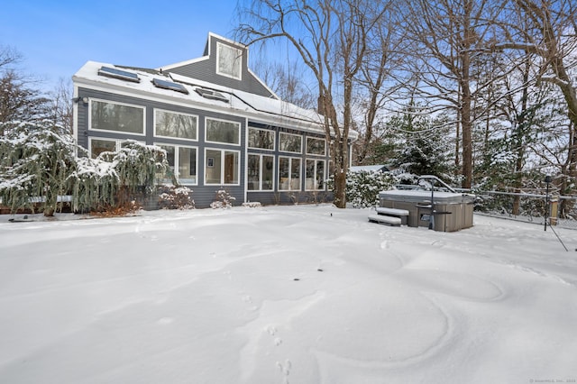 exterior space featuring a hot tub and a sunroom