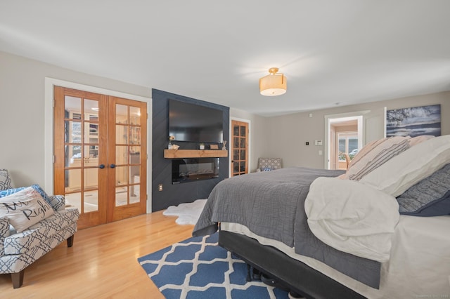 bedroom featuring wood-type flooring and french doors