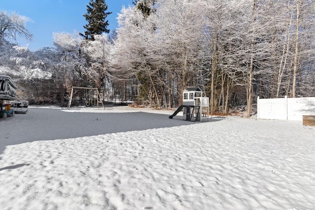 snowy yard with a playground