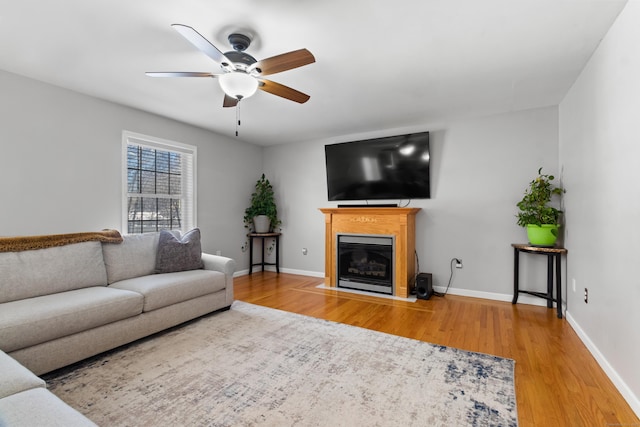 living room with hardwood / wood-style flooring and ceiling fan