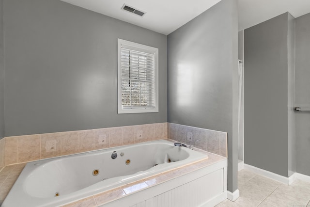 bathroom featuring tile patterned floors and a bath