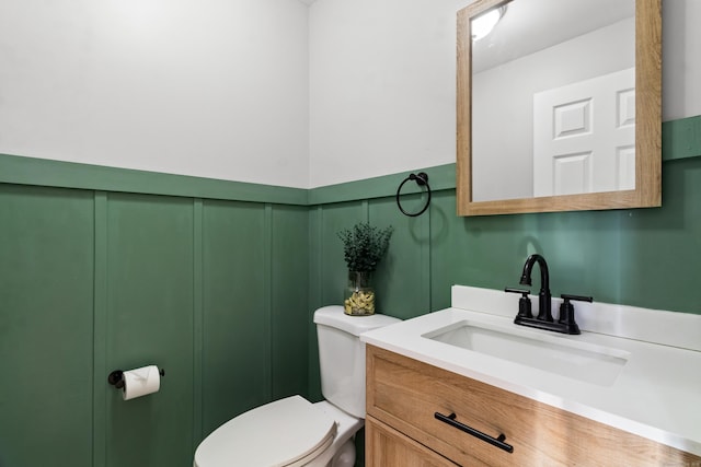 bathroom with toilet and vanity