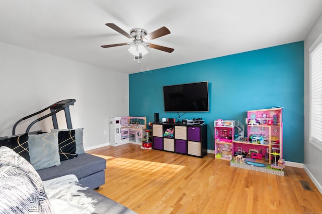 living room featuring hardwood / wood-style flooring and ceiling fan