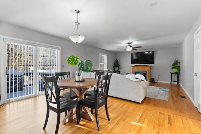 dining space featuring light hardwood / wood-style floors and ceiling fan