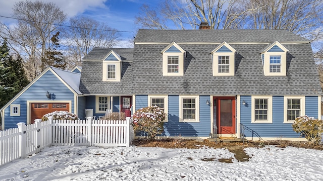 new england style home featuring a garage