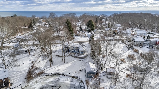 snowy aerial view featuring a water view