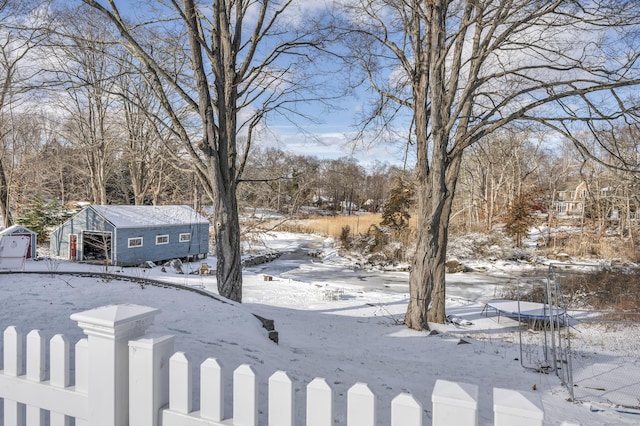 yard covered in snow with a shed