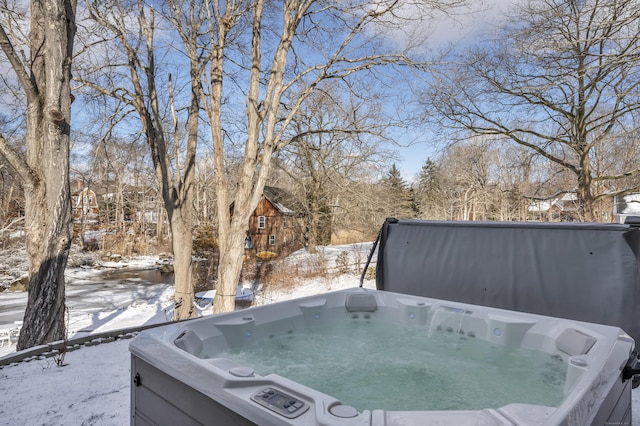 yard layered in snow featuring a hot tub