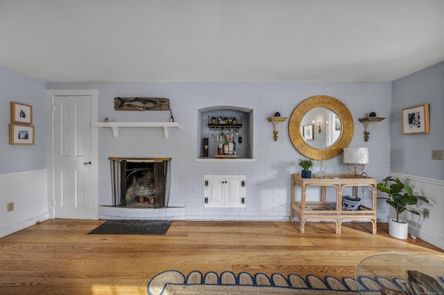 living room with wood-type flooring and a fireplace