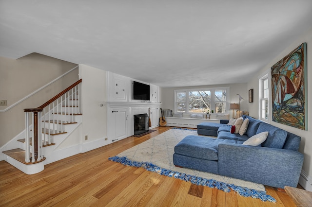 living room with light wood-type flooring and baseboard heating