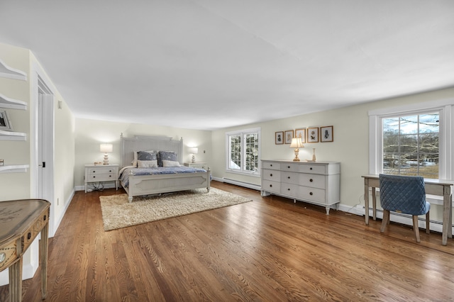 bedroom featuring multiple windows, a baseboard radiator, and hardwood / wood-style floors